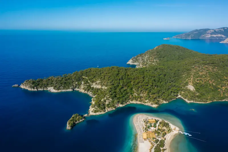 Green trees on island surrounded with blue waters in Fethiye